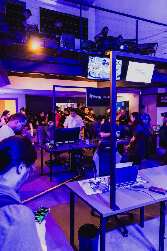 pexels-photo-19012058-19012058 Thrilling gaming convention featuring technology displays and interactive entertainment under dramatic purple lighting.